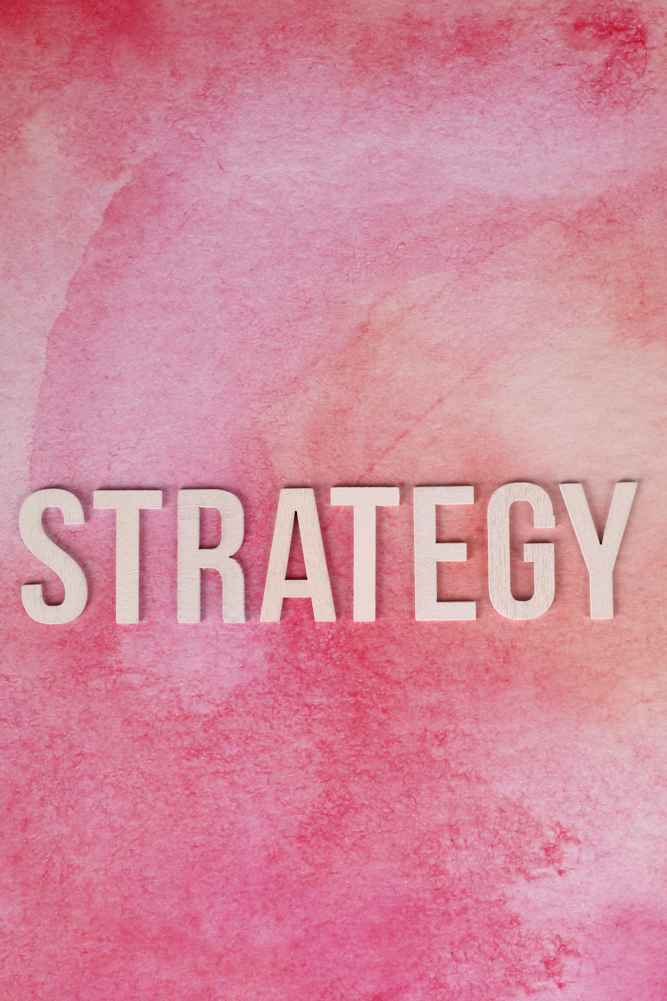 Bold 'Strategy' text on a textured pink background, perfect for business presentations.