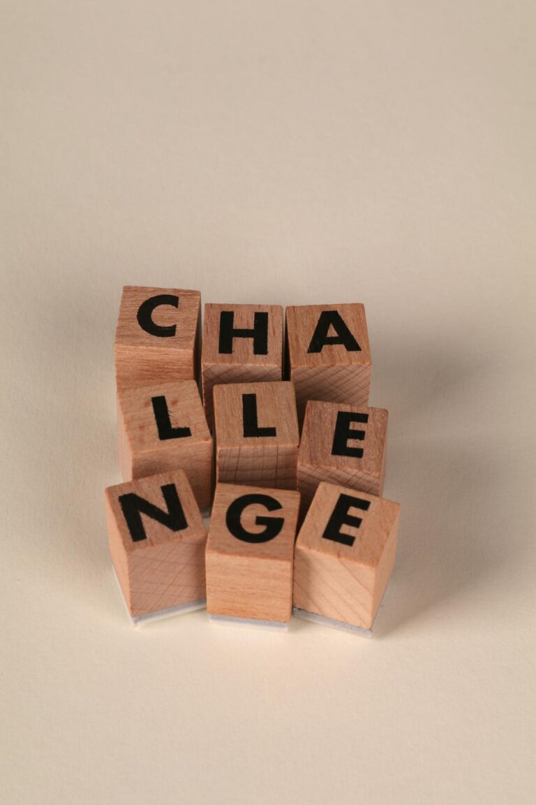 Wooden blocks forming the word 'CHALLENGE' symbolize problem-solving and strategy.